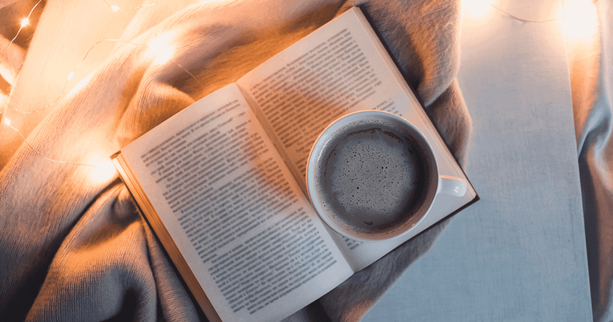 Cannabis books: A book lying on a throw with a cup of black coffee