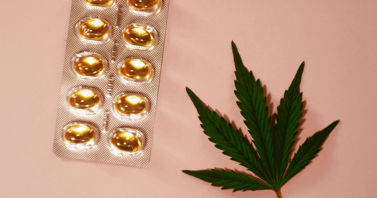 Migraine: A green cannabis leaf next to a blister packet of cannabis capsules on a salmon pink background