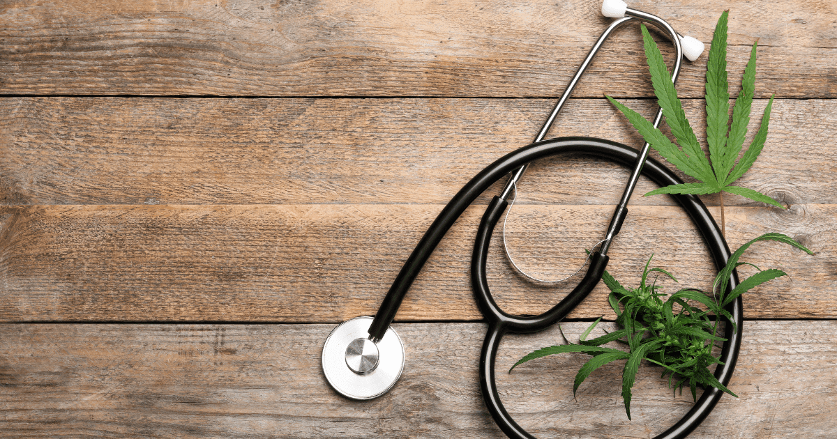 Fibromyalgia: A stethoscope on a wooden surface surrounded by cannabis leaves