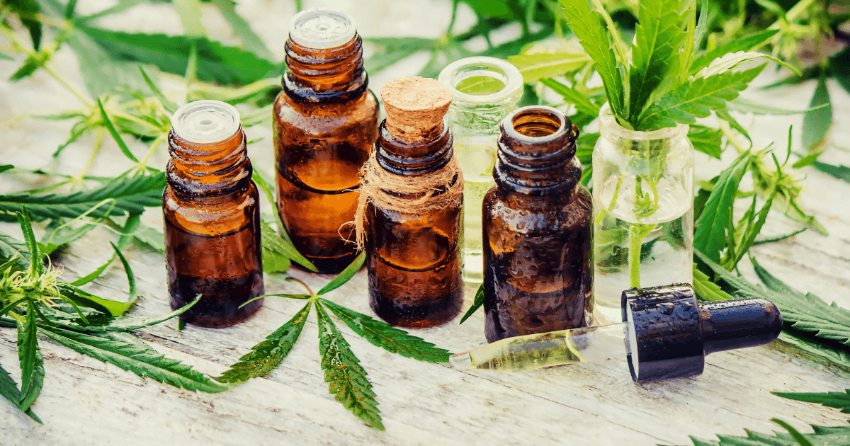 ADHD: A row of brown oil bottles with no lids surroundd by green cannabis leaves
