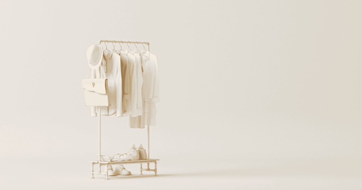 Hemp fashion: A row of white clothing on a single rail in the middle of an all white room. The clothing is all cream or white with a hat perched on the end of the rail