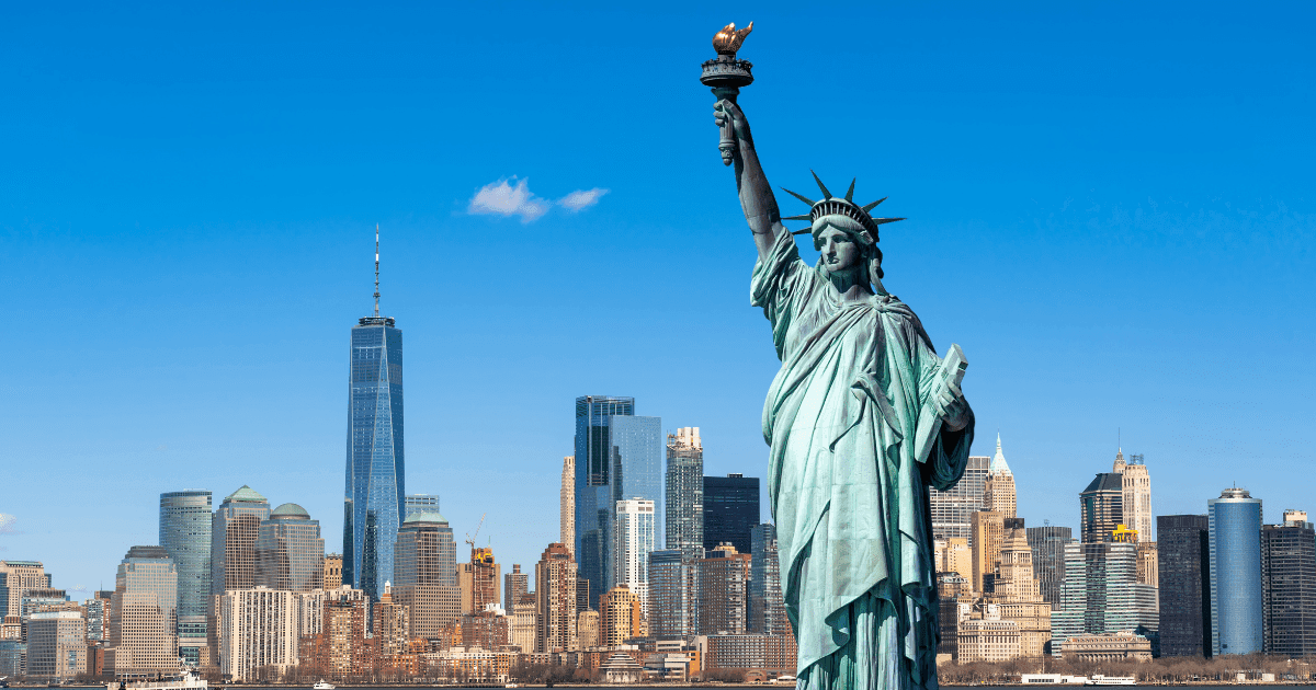 New York: The statue of Liberty against a blue sky and the skyline of New York city
