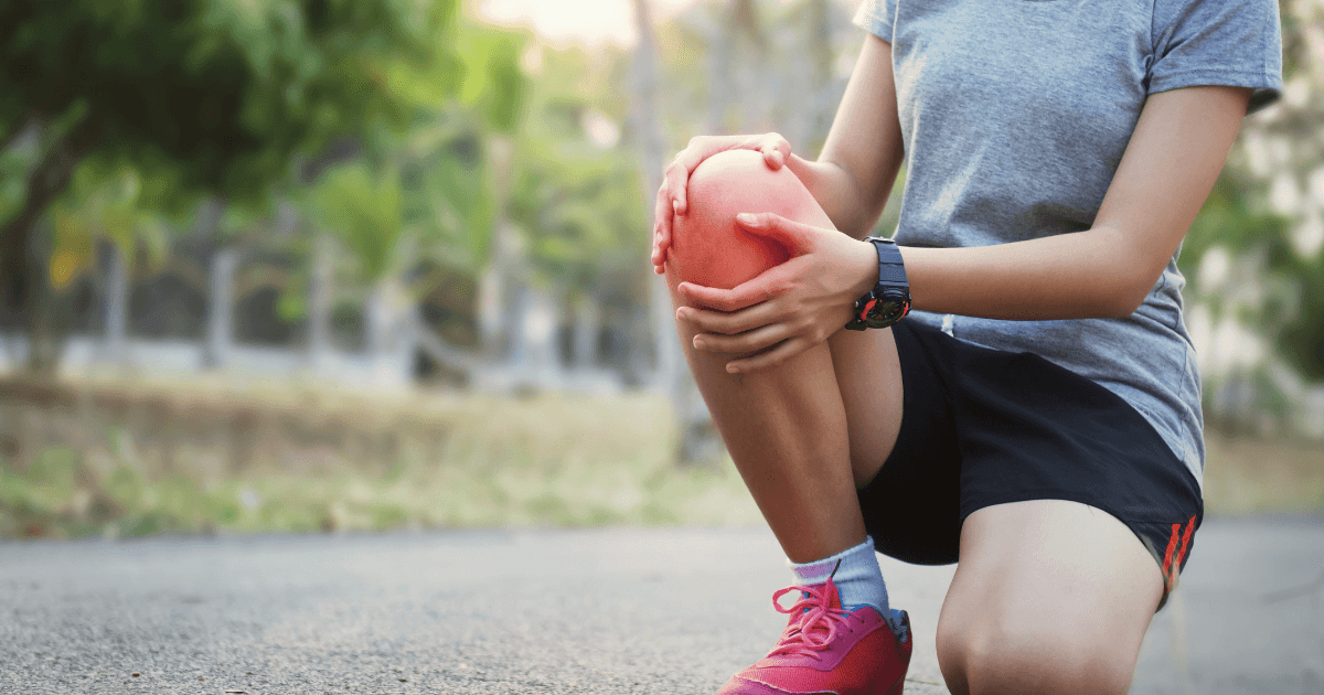 Chronic pain: A woman crouched down holding her knee which is red with pain