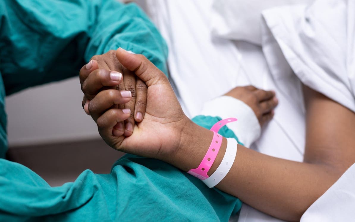 Cancer: Doctor holding patients hand