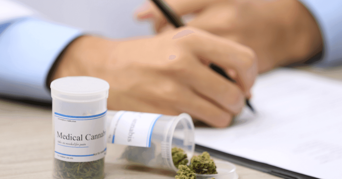 : A person writing on a medical notepad prescribing medical cannabis