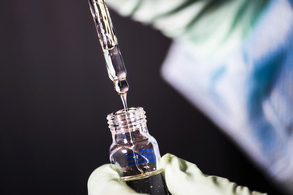 Researcher studying bottle of cannabis oil