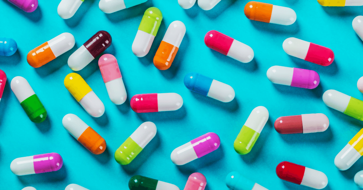 Opioid: A handful of pills on a bright blue background
