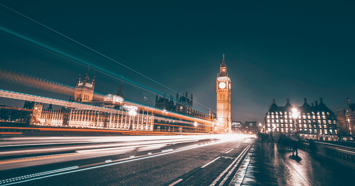 London: a busy road showing the big Ben clock and traffic rushing by which has been blurred to look like lights