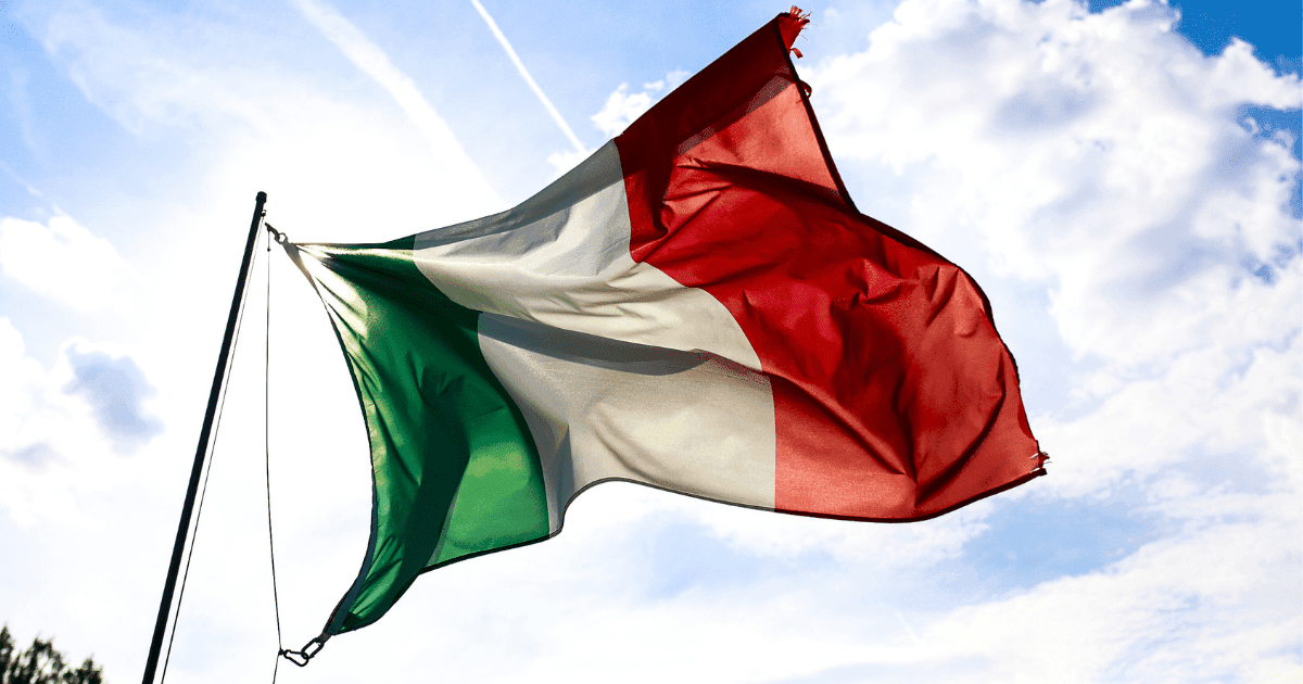 Italy: An Italian flag floating against the blue sky