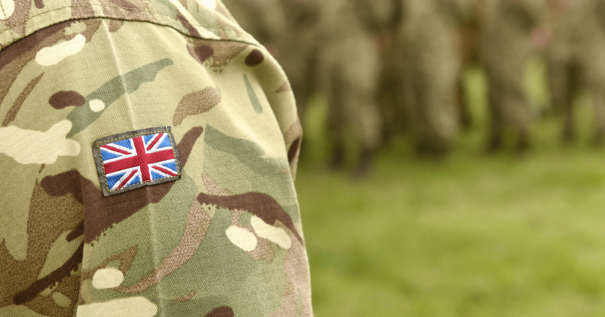 Veterans and CBD: The shoulder of an army person wearing green combat gear with a British flag. on it