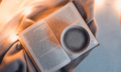 Cannabis books: A book lying on a throw with a cup of black coffee