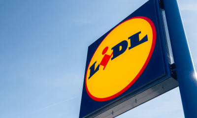 Lidl: A sign for German brand Lidl against a clear blue sky