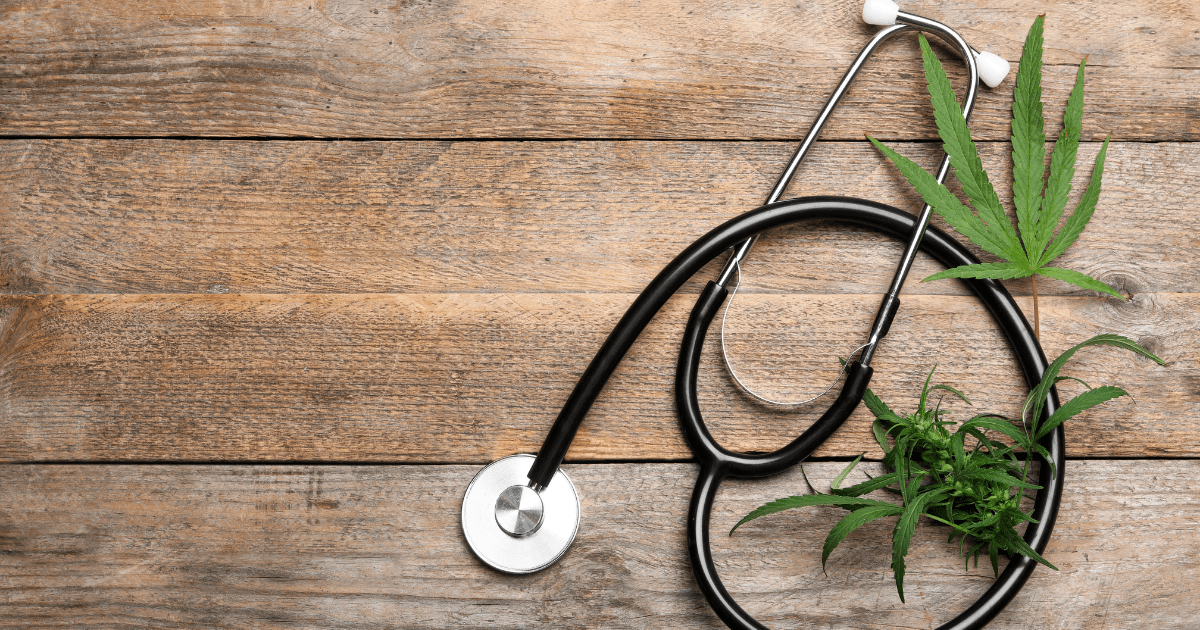 Fibromyalgia: A stethoscope on a wooden surface surrounded by cannabis leaves