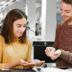BMW: A man and a woman examine different panels of material at a desk in a white office room