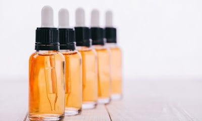 Clint Eastwood: A row of glass bottles with yellow CBD oil them
