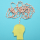 ADHD: A blue background with a cartoon head with a string jumbled up above it to represent thoughts