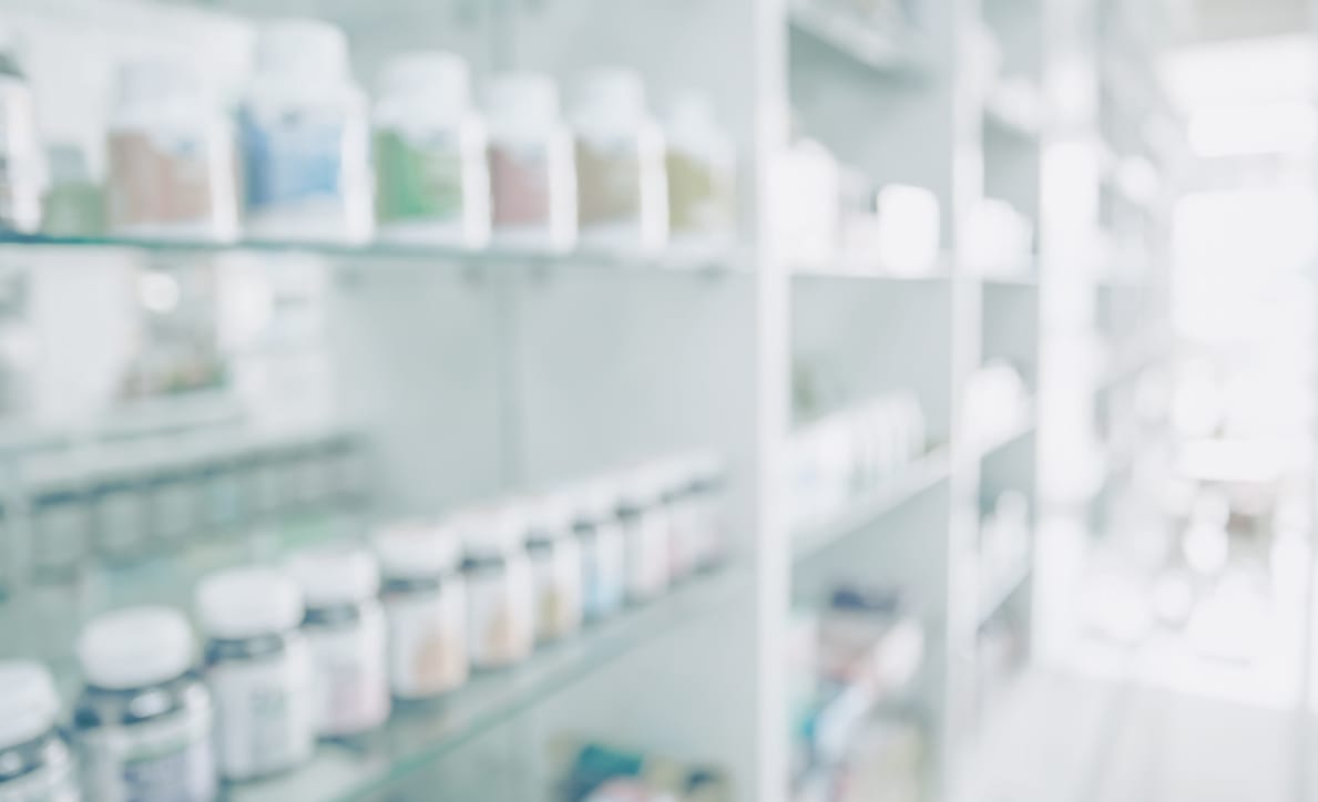 Dispensary Green: Blurred image of pharmacy shelves