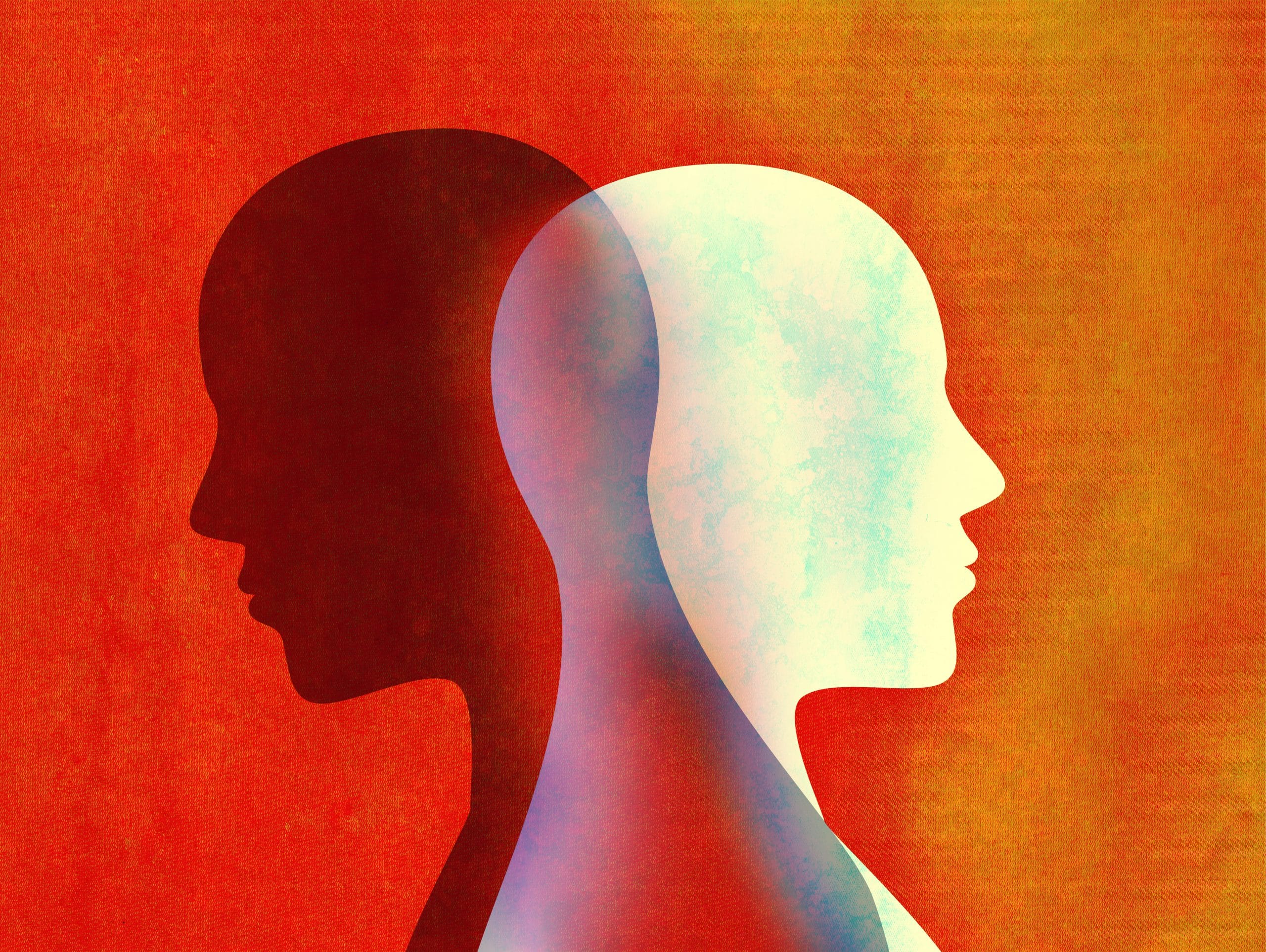 Mental health: Two heads in different colours to highlight hidden mental health. One head is dark while the other is light against an orange background 