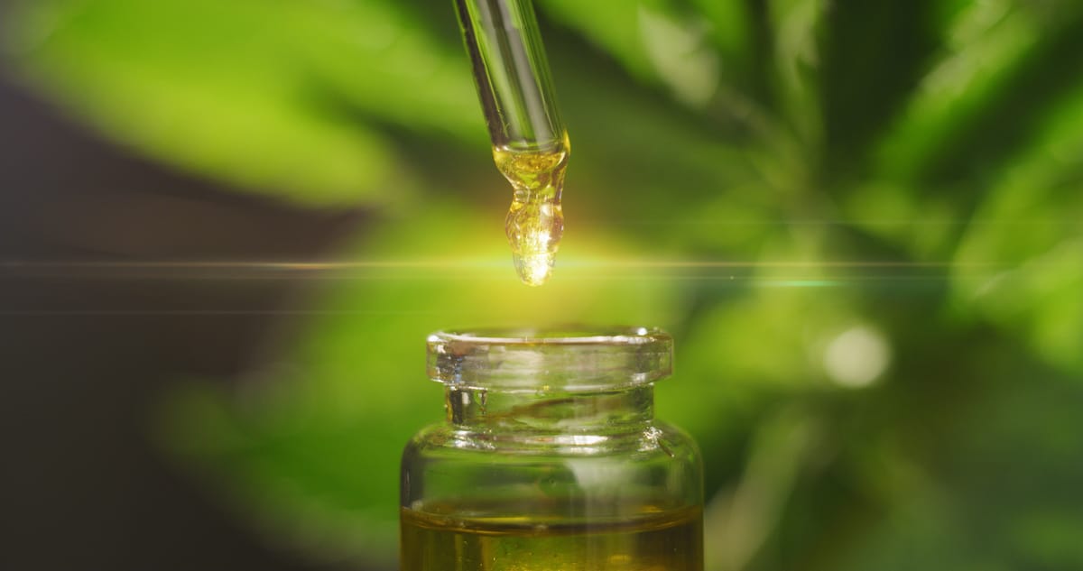 A close up of a medical cannabis oil and dropper