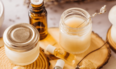 Menopause: Two jars of CBD balm sit on a sideboard with a brown bottle of aromatherapy oil