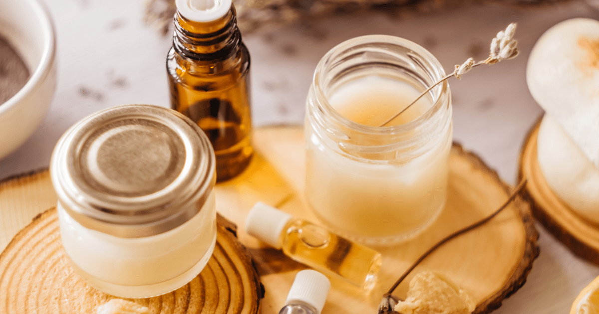 Menopause: Two jars of CBD balm sit on a sideboard with a brown bottle of aromatherapy oil
