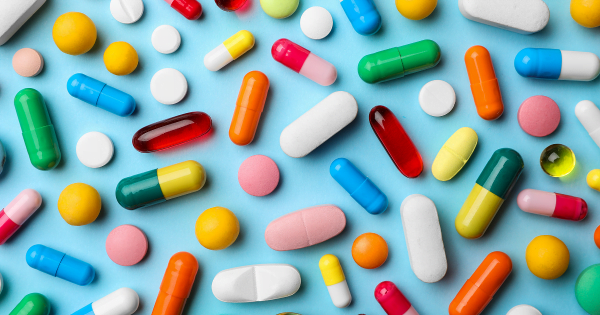 Opioids: A collection of brightly coloured pills on a blue surface