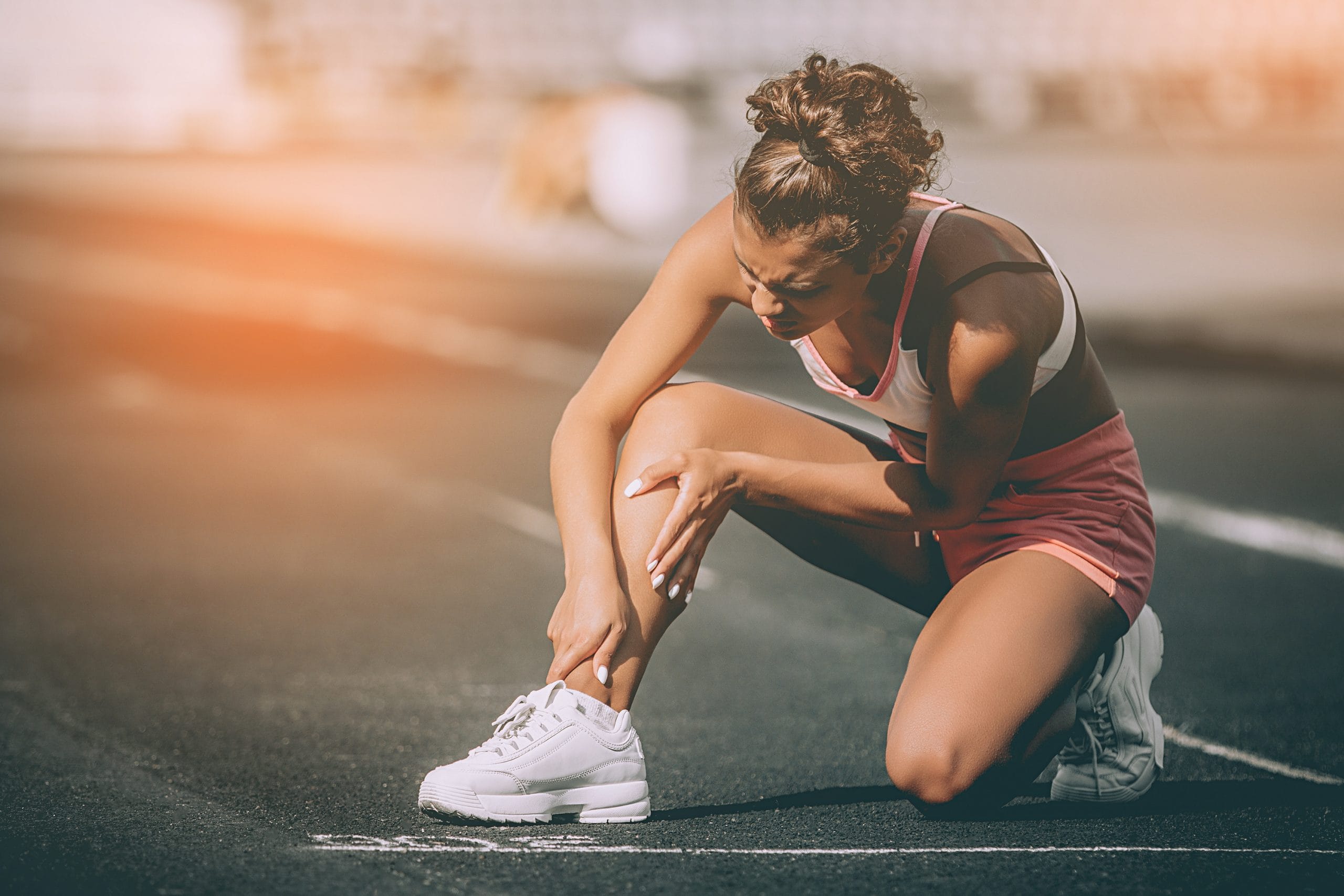 CBD: A woman holding her knee after running
