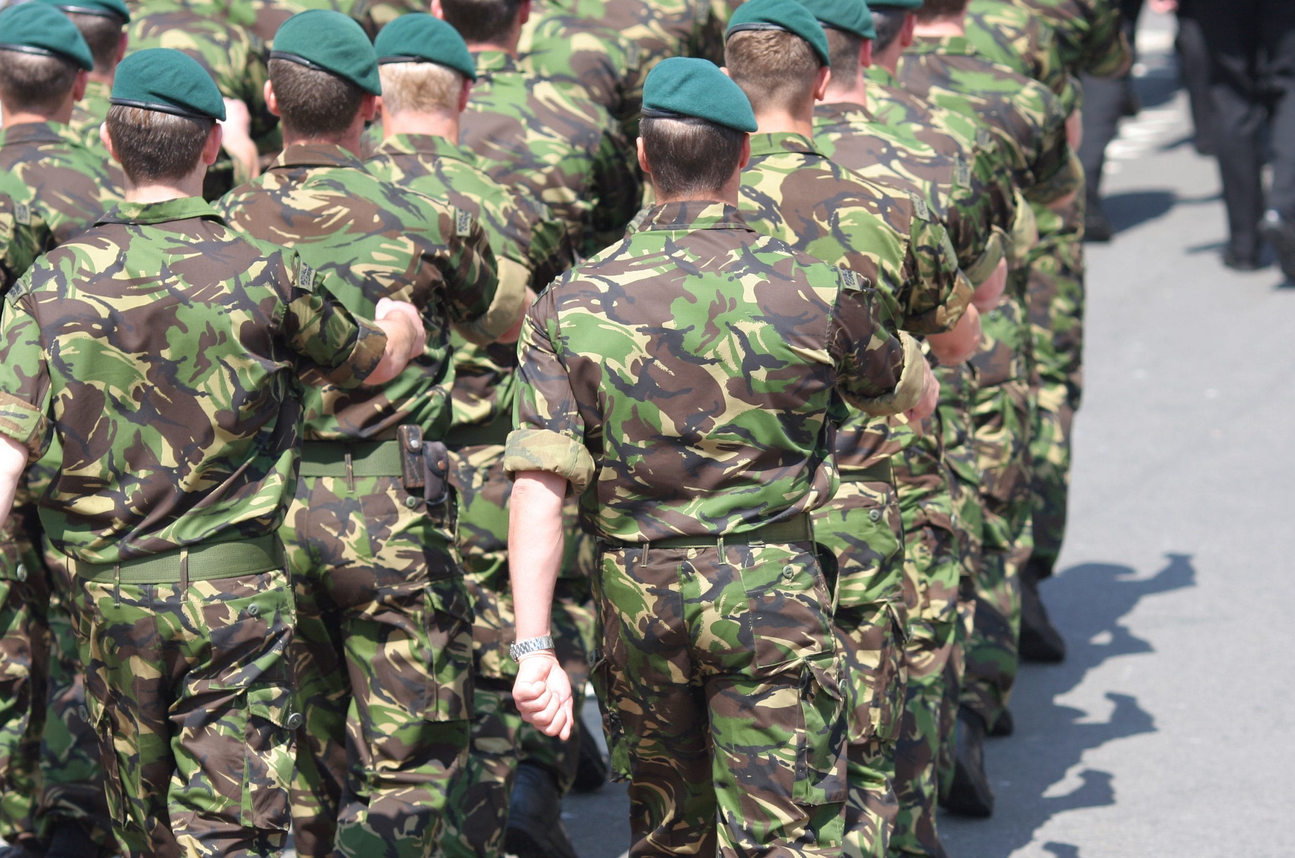 Veterans: Army men marching in uniform lines