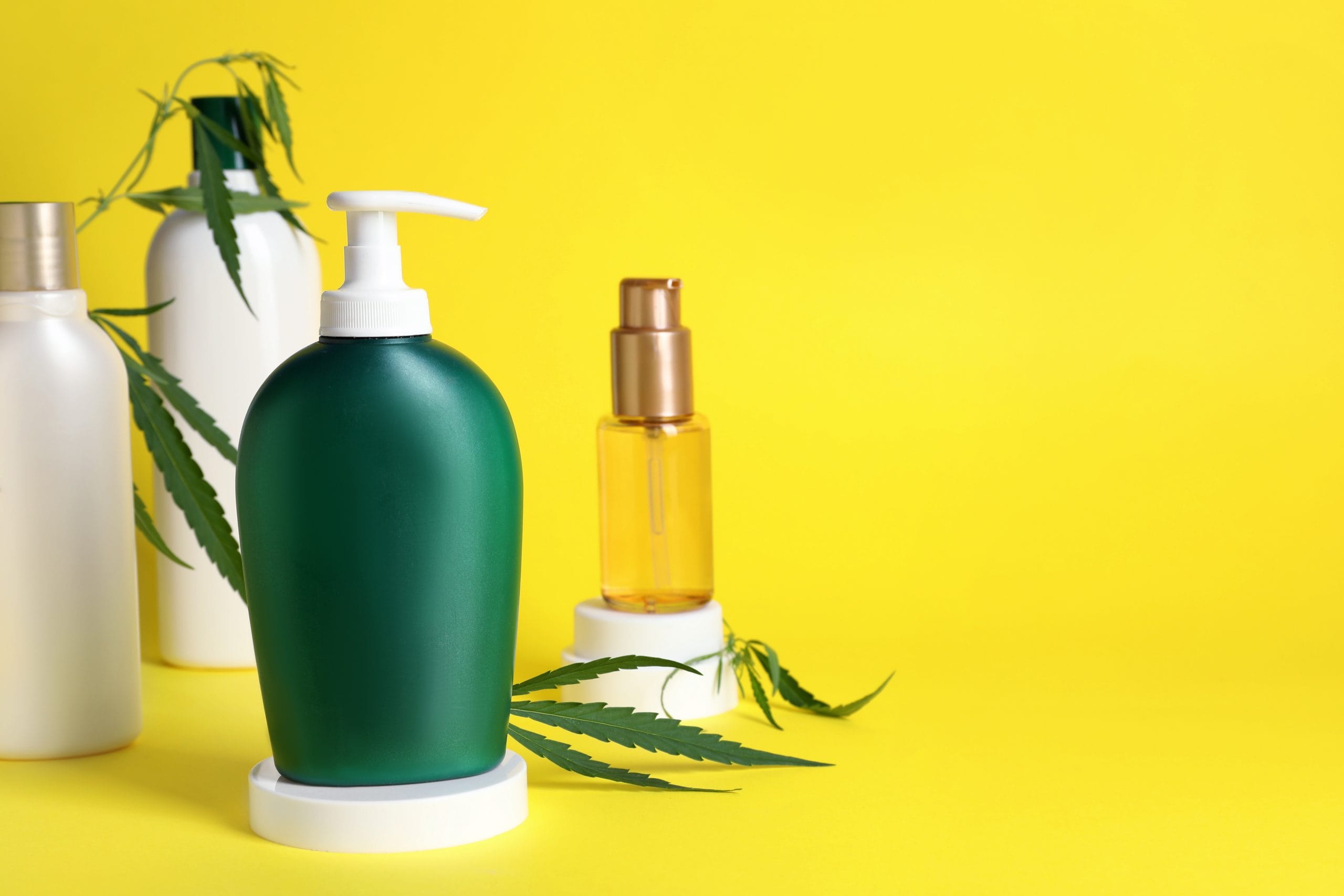 hemp seed leaf: A collection of bottles containing CBD against a yellow background.