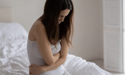 IBD: A woman holding her stomach in pain from IBD