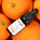Trojan Hemp Co.: A collection of oranges with a bottle of Uplift CBD on top