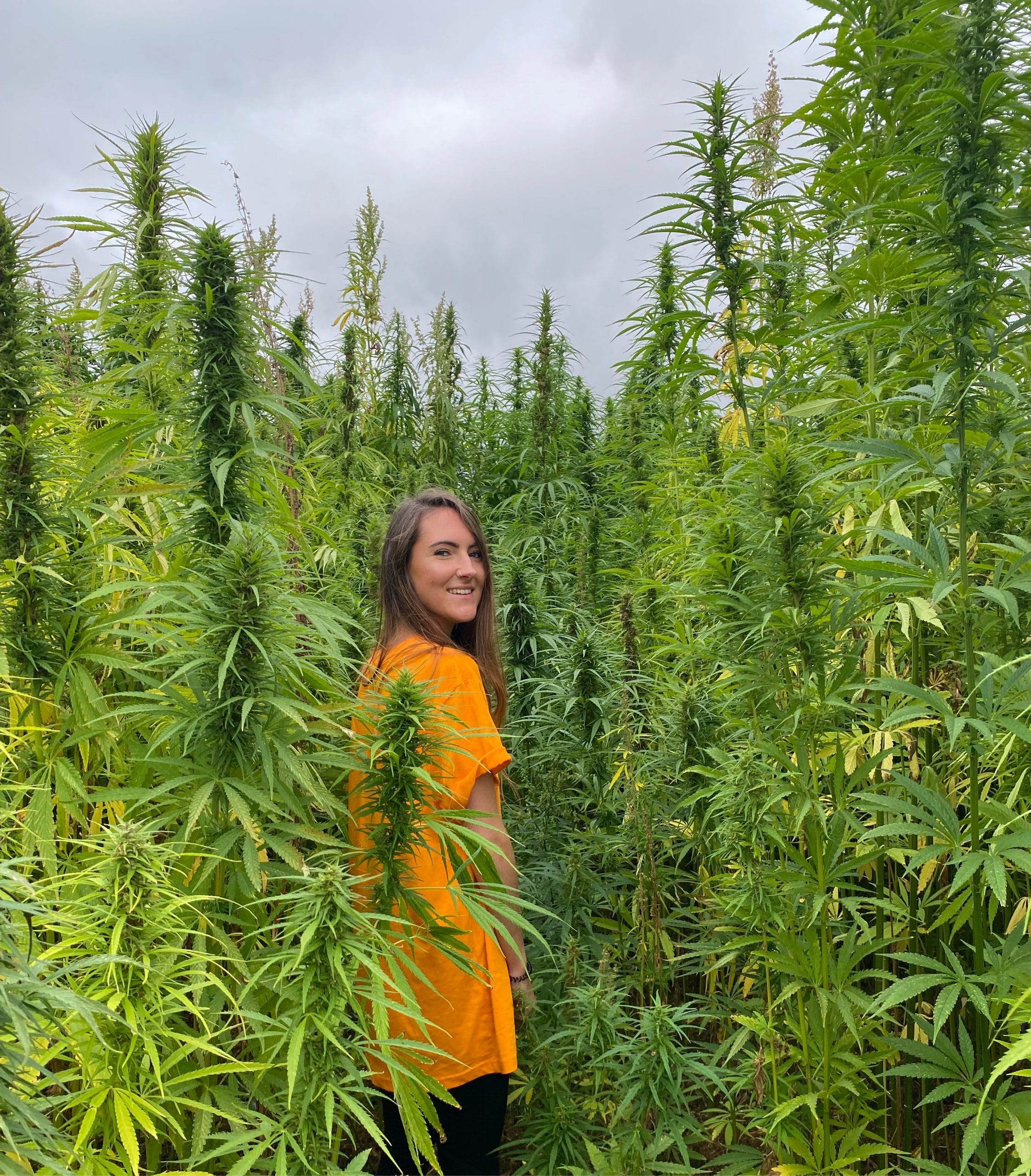 CBD store owner Sophie in a field of hemp plants