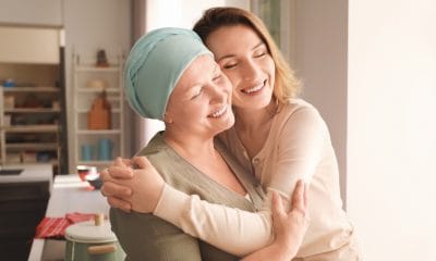 Cancer:Young woman visiting her mother with cancer indoors