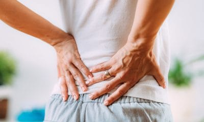 Back pain: A person holding their lower back in pain