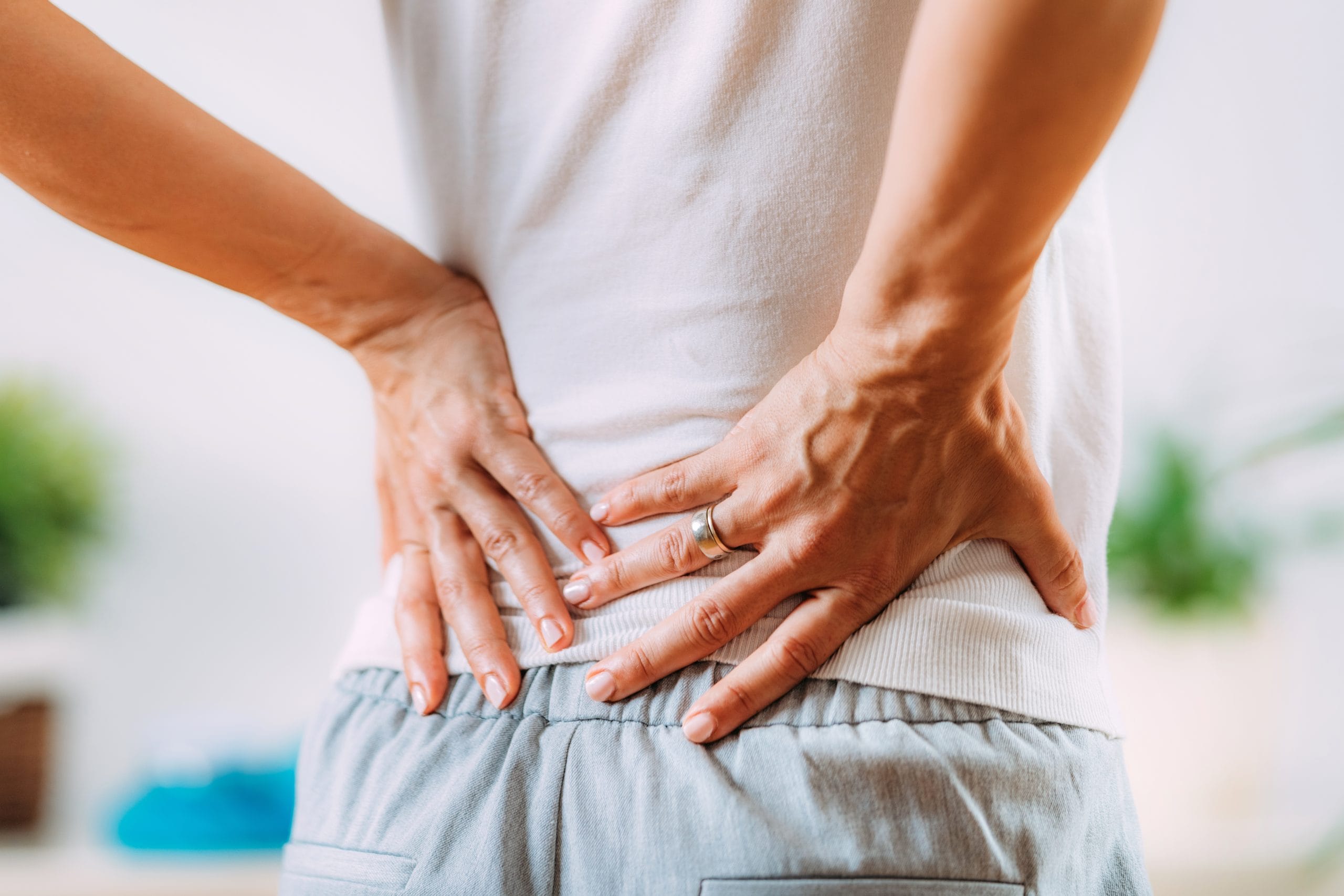 Back pain: A person holding their lower back in pain