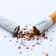 Smoking: A cigarette stubbed out on a white background