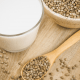Hemp milk: A glass of hemp milk and seeds on a wooden surface
