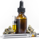Glioblastoma: A bottle of CBD with a vape. There are two cartridges of CBD e-liquid