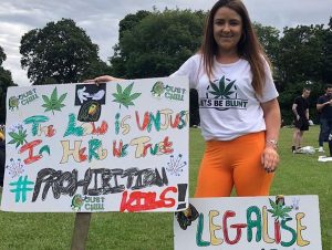 Aimee Brown, Ireland cannabis campaigner holding a legalise cannabis poster at protest