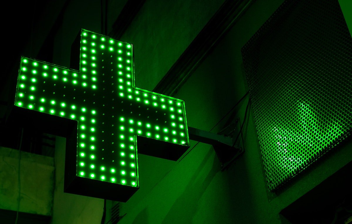 Cannabis pharmacy icon lit up in neon green